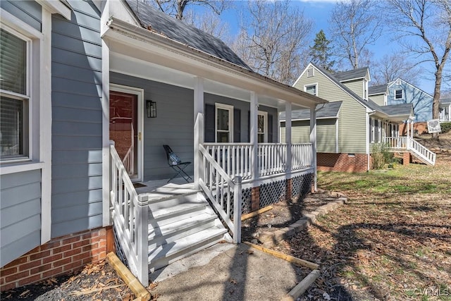 entrance to property with roof with shingles and covered porch