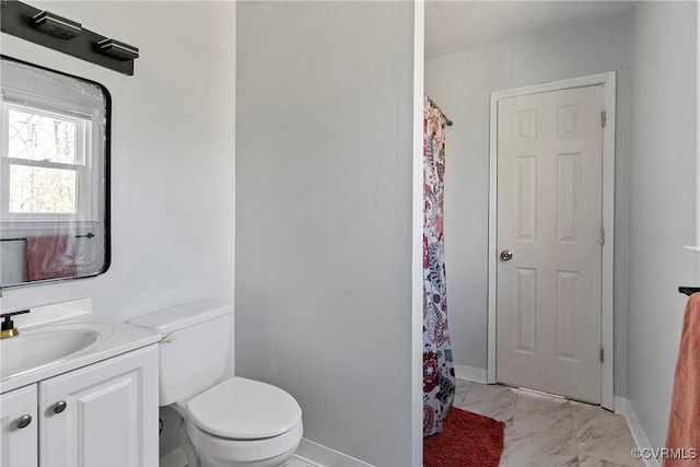 bathroom featuring toilet, marble finish floor, a shower with shower curtain, baseboards, and vanity