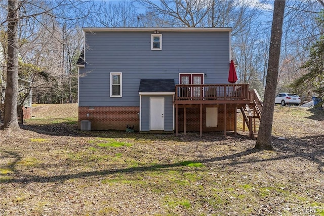 rear view of property with stairway and a wooden deck