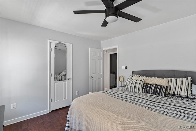 bedroom featuring wood finished floors, baseboards, and ceiling fan