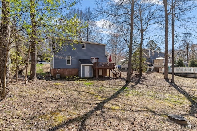 rear view of house with stairway and a deck