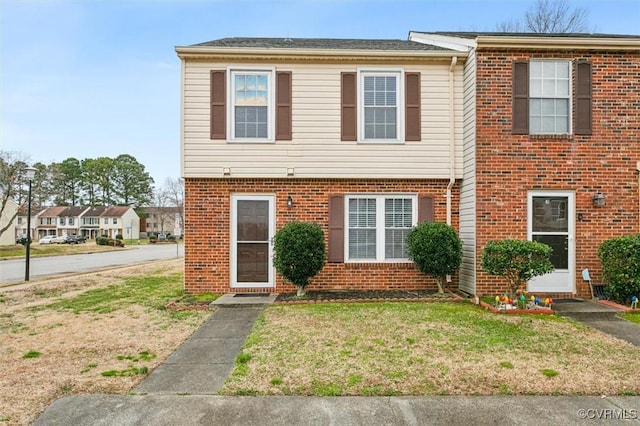 view of front of house with brick siding and a front yard