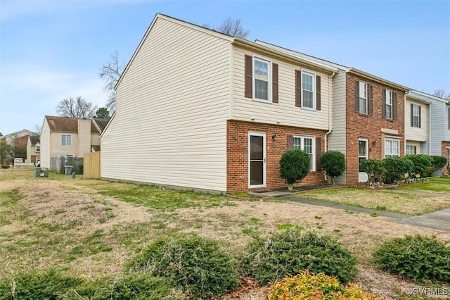 view of side of home with a yard and brick siding