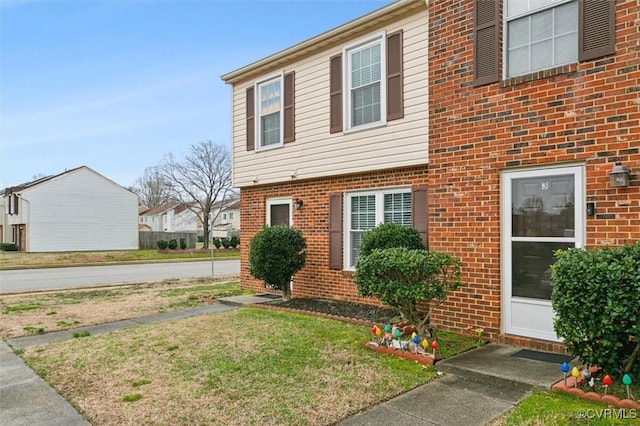 view of front of house with brick siding and a front yard