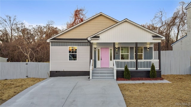 bungalow-style home featuring crawl space, covered porch, and fence