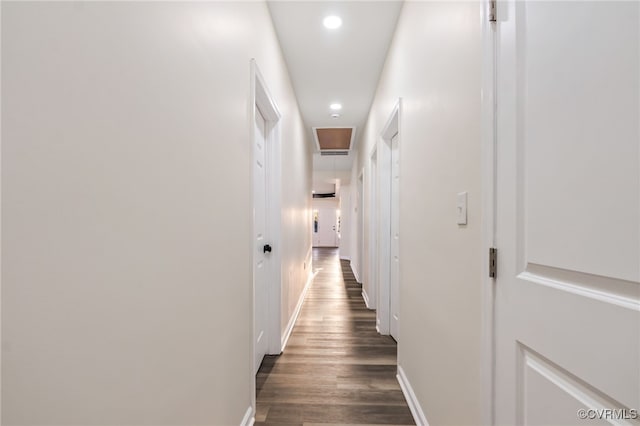 corridor with recessed lighting, dark wood-style floors, and baseboards