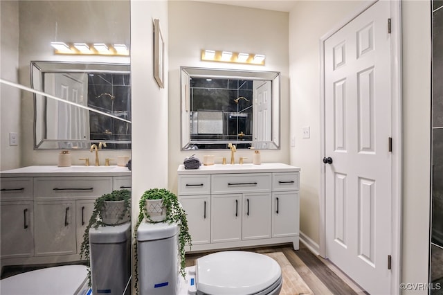 full bath featuring vanity, toilet, wood finished floors, and a shower