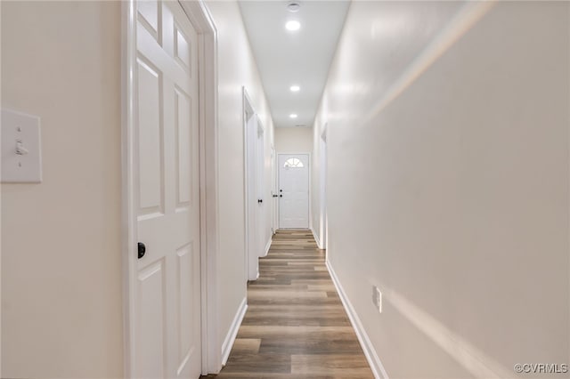 hallway featuring recessed lighting, baseboards, and wood finished floors