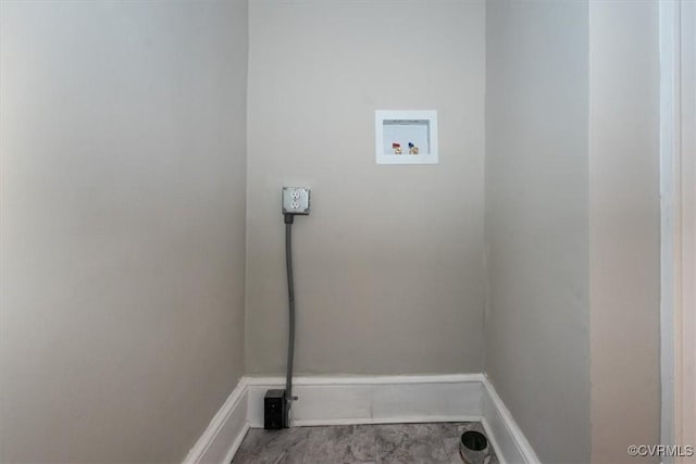 clothes washing area with baseboards, washer hookup, and laundry area