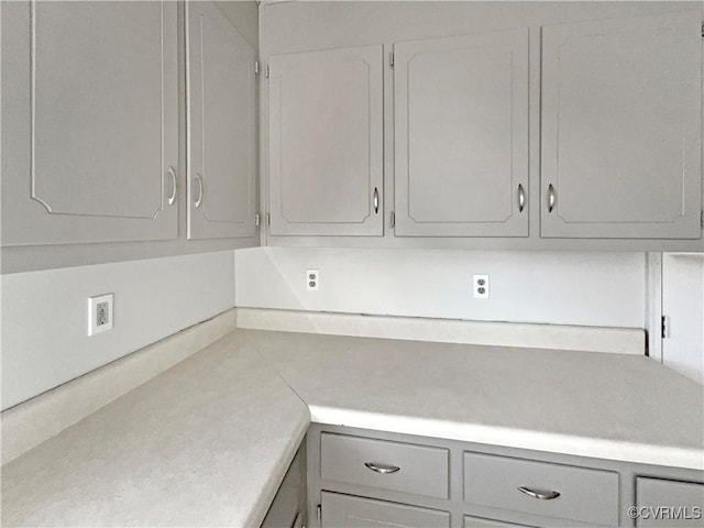 kitchen featuring gray cabinets and light countertops