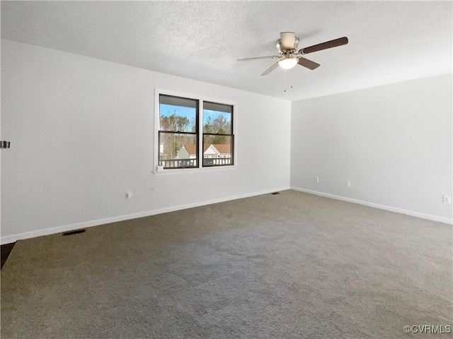 spare room featuring visible vents, baseboards, carpet floors, ceiling fan, and a textured ceiling