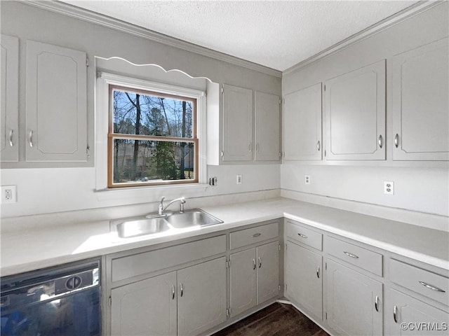 kitchen with ornamental molding, a sink, light countertops, a textured ceiling, and dishwasher