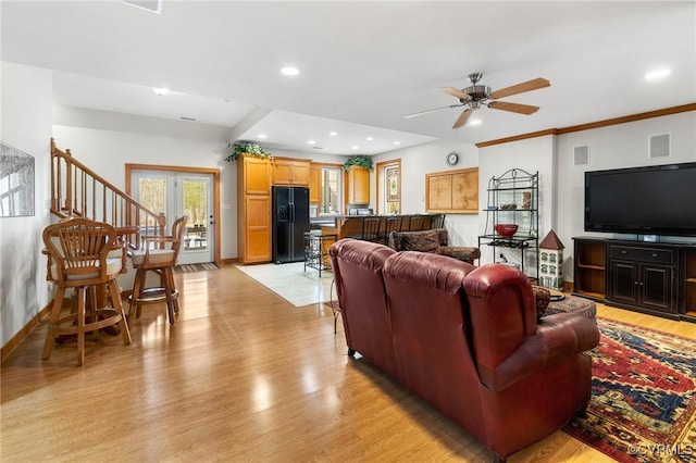 living room featuring visible vents, baseboards, ceiling fan, recessed lighting, and light wood-style flooring