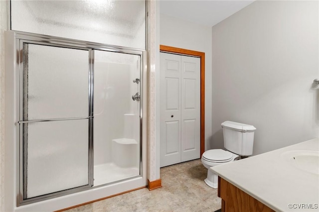 full bath with a closet, toilet, a stall shower, and vanity