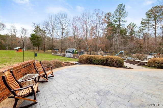 view of patio / terrace featuring an outdoor structure and a shed