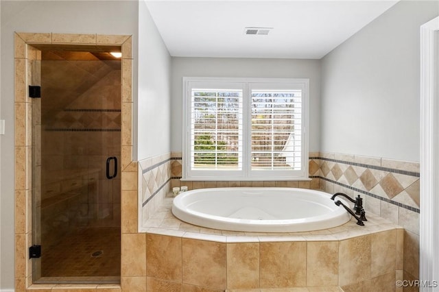 bathroom with a stall shower, visible vents, and a bath