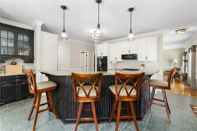 kitchen featuring black appliances, glass insert cabinets, backsplash, and ornamental molding