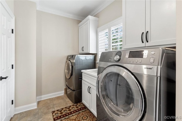 clothes washing area with ornamental molding, washing machine and dryer, cabinet space, light tile patterned floors, and baseboards