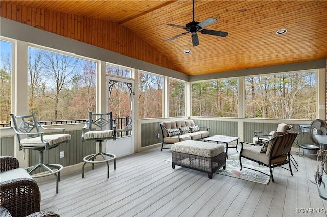 sunroom / solarium with a wealth of natural light, wooden ceiling, ceiling fan, and vaulted ceiling