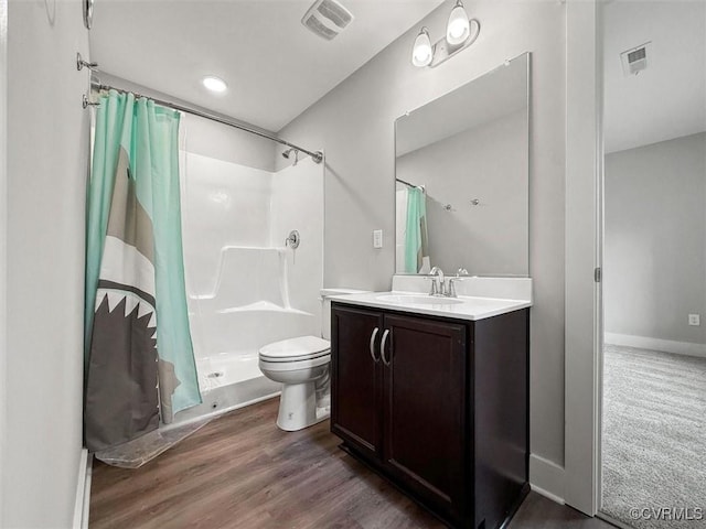 bathroom featuring visible vents, curtained shower, vanity, and toilet