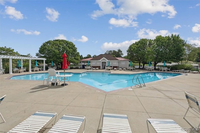 community pool featuring a patio area, fence, and a pergola