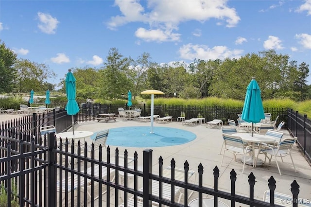 view of pool featuring a patio and fence