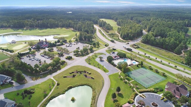 aerial view with a forest view and a water view