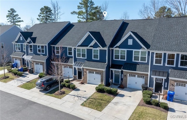 townhome / multi-family property featuring a residential view, driveway, and roof with shingles