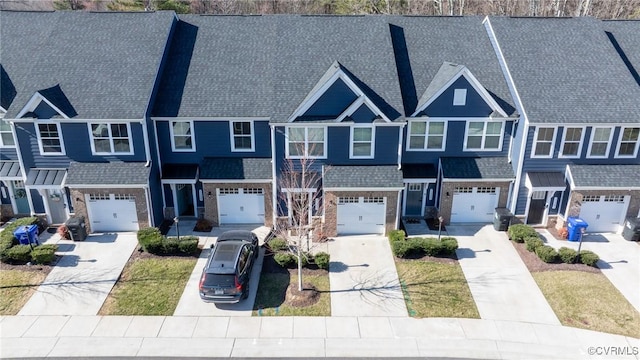 townhome / multi-family property featuring a residential view, driveway, and a garage