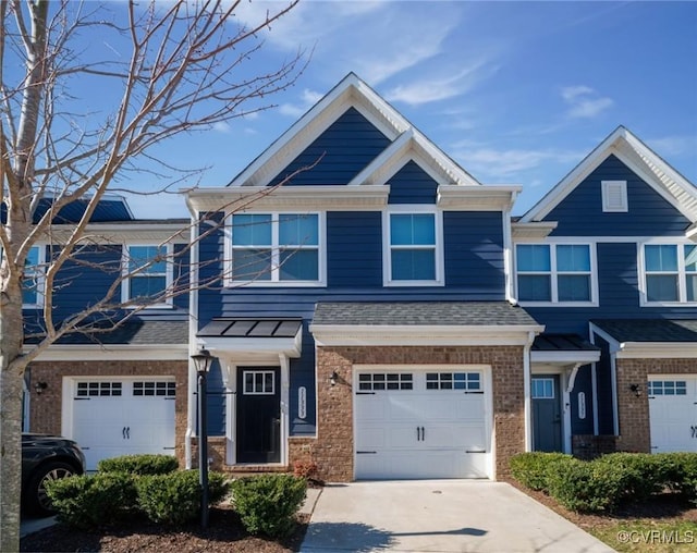 multi unit property featuring concrete driveway, a garage, brick siding, and a shingled roof