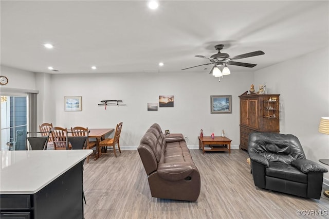 living room with recessed lighting, light wood-type flooring, baseboards, and ceiling fan