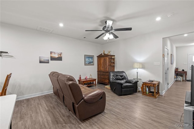 living area featuring a ceiling fan, wood finished floors, visible vents, baseboards, and recessed lighting