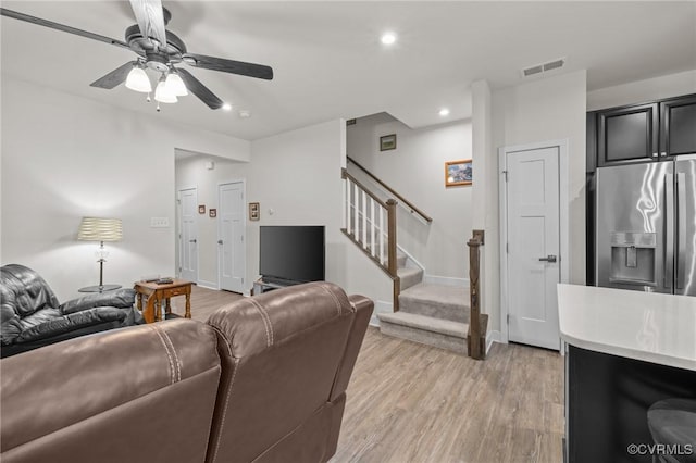 living room featuring visible vents, a ceiling fan, recessed lighting, stairway, and light wood finished floors