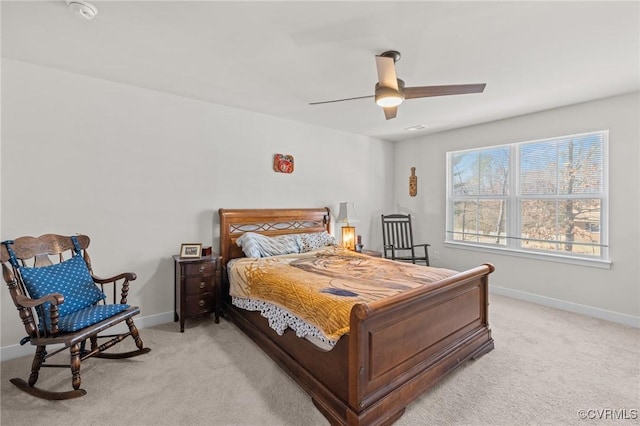 bedroom with baseboards, light carpet, and a ceiling fan