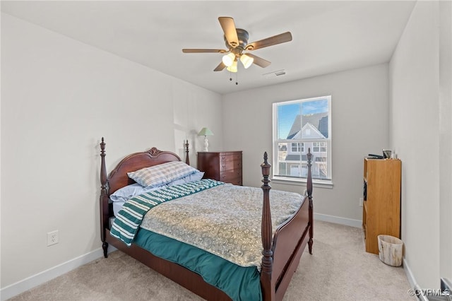 bedroom with visible vents, light carpet, and baseboards