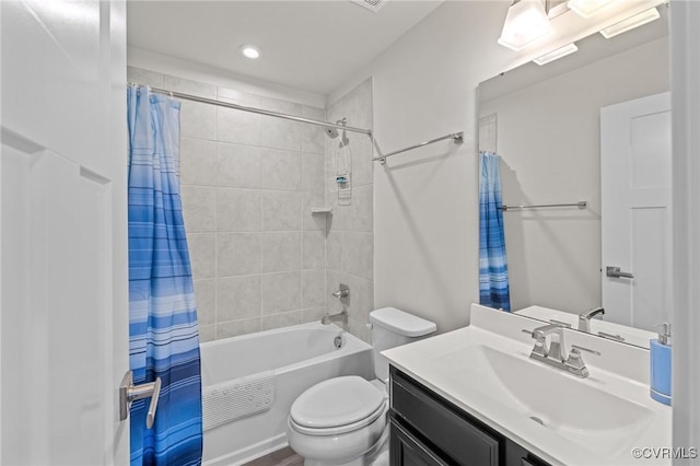 bathroom with vanity, toilet, and shower / tub combo with curtain