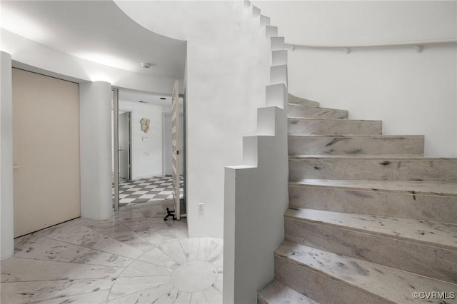 staircase featuring tile patterned floors