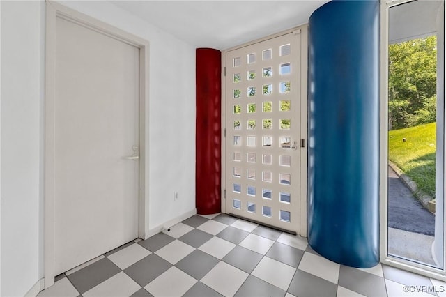 entryway featuring tile patterned floors and baseboards