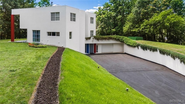 view of front of house with stucco siding and a front lawn