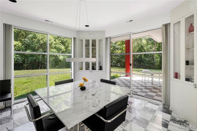 sunroom / solarium with plenty of natural light and visible vents