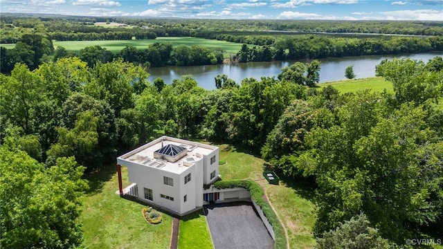 birds eye view of property with a water view and a view of trees