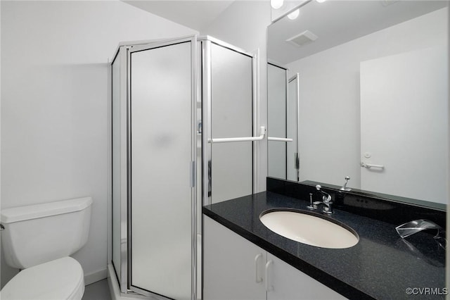 full bathroom featuring vanity, a shower stall, toilet, and visible vents