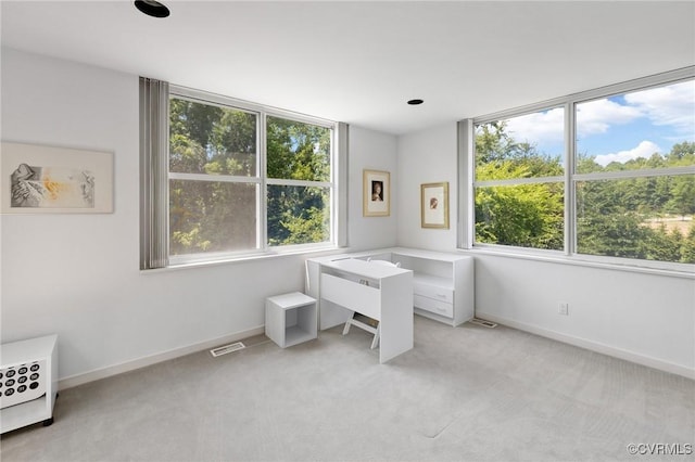 office space featuring visible vents, baseboards, and a healthy amount of sunlight