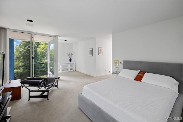 bedroom featuring carpet flooring, visible vents, baseboards, and expansive windows