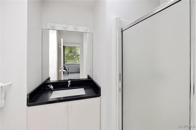 bathroom with an enclosed shower and vanity