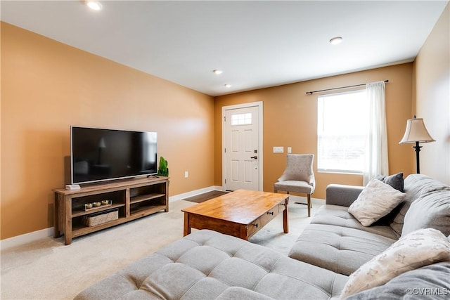 carpeted living area with recessed lighting and baseboards