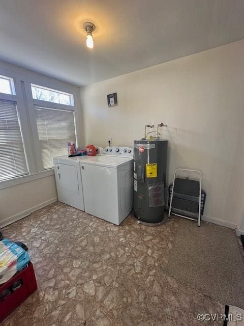 washroom with washing machine and clothes dryer, laundry area, electric water heater, and baseboards