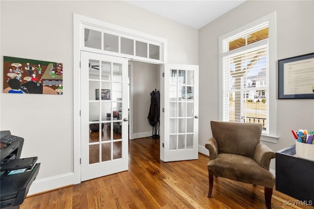 sitting room featuring french doors, baseboards, and wood finished floors