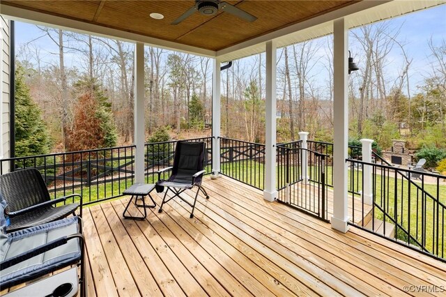 deck featuring a yard and a ceiling fan