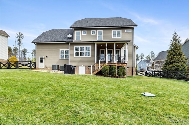 rear view of house with a gate, a fenced backyard, a yard, cooling unit, and stairway